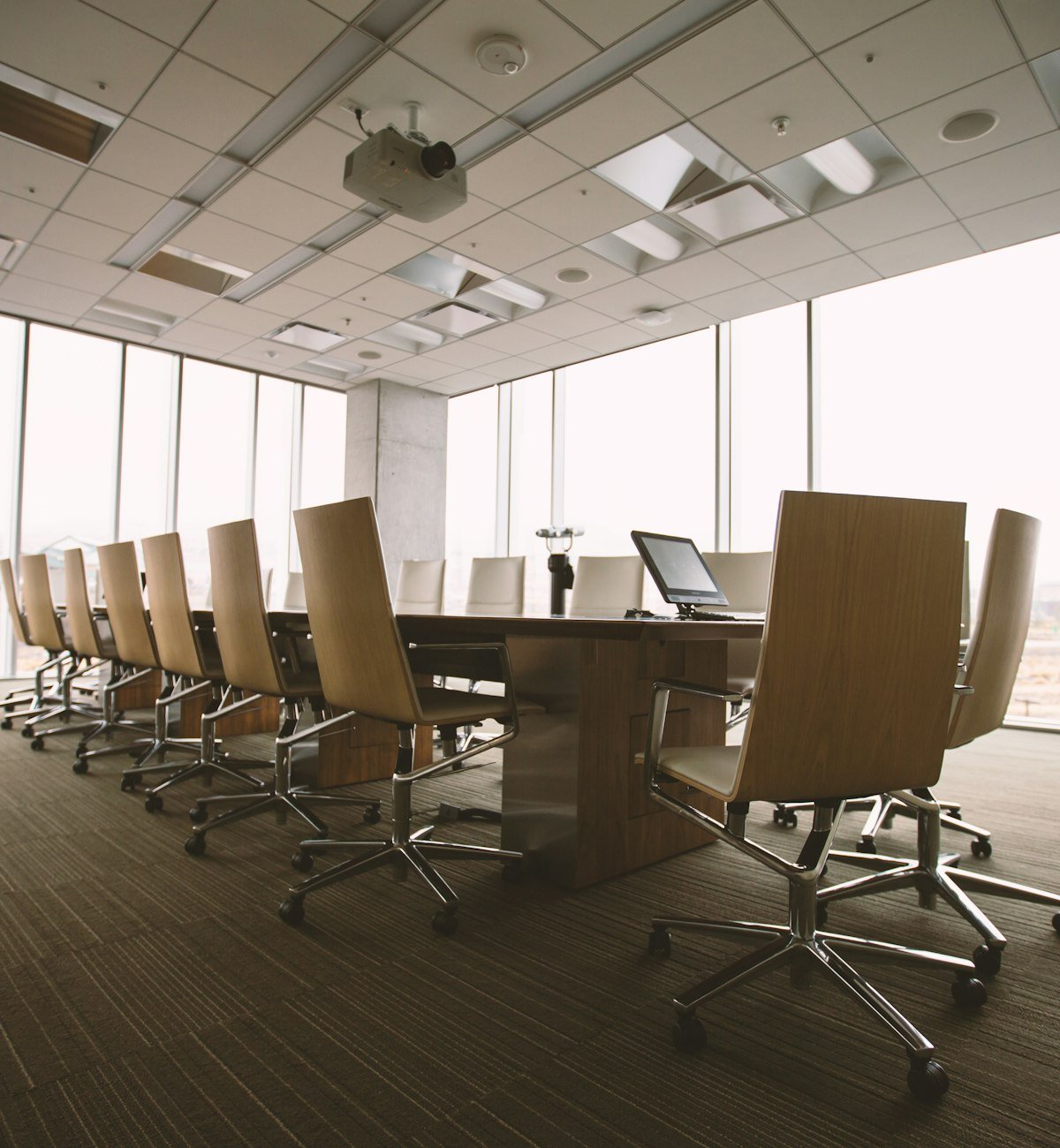 Boardroom with a long table and floor-to-ceiling windows