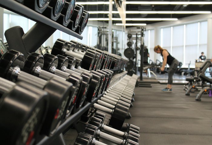Rows of dumbbells in a bright gym
