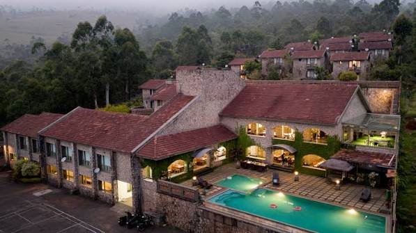 Aerial view of the resort at dusk with the pool lit up