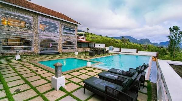 Swimming pool with loungers overlooking the mountains
