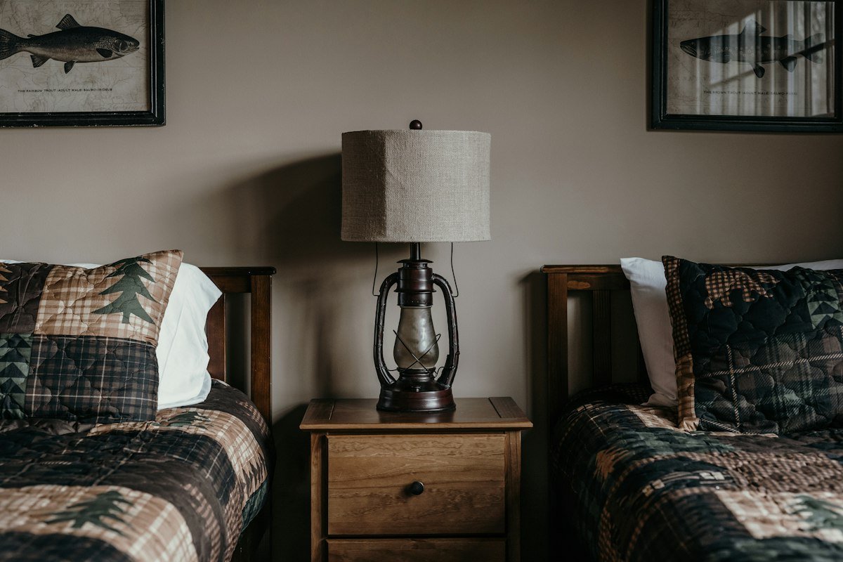 Twin bedroom with bedside lamp